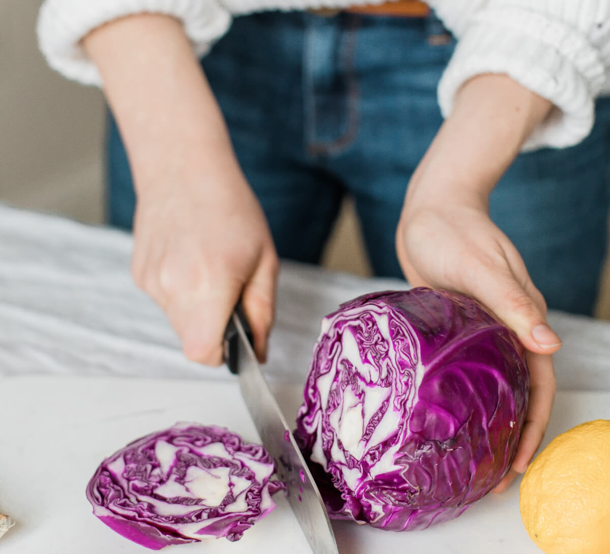 Person cutting a red cabbage