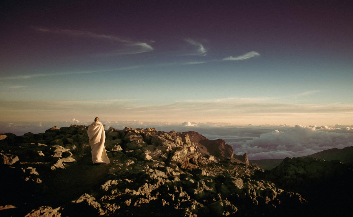 Monk looking out over the horizon at sunrise